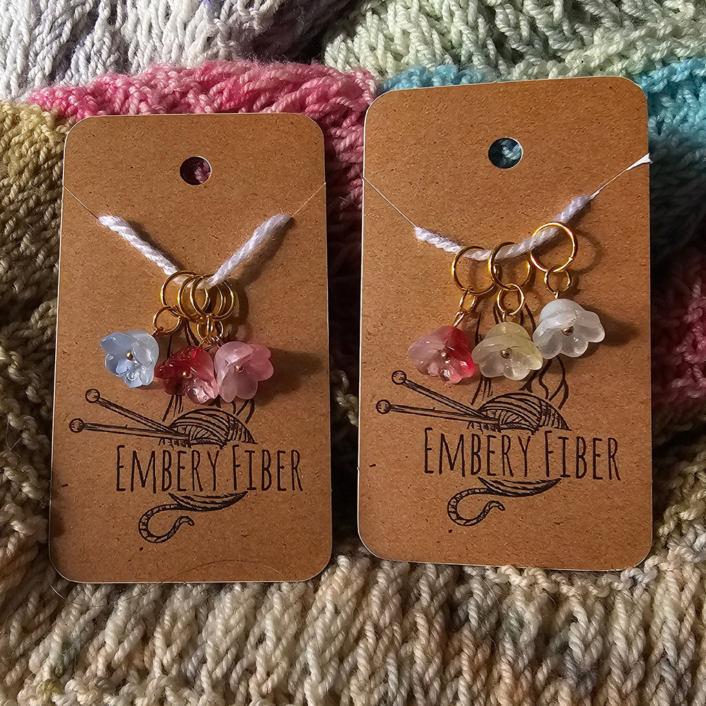 3 Glass Flower Stitch Markers on knitted background